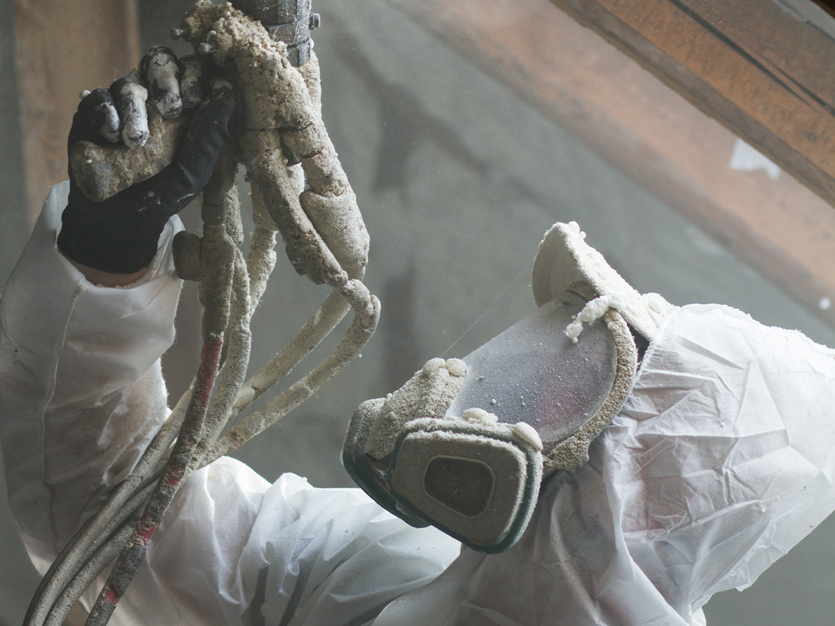 spray foam contractor wearing respirator mask