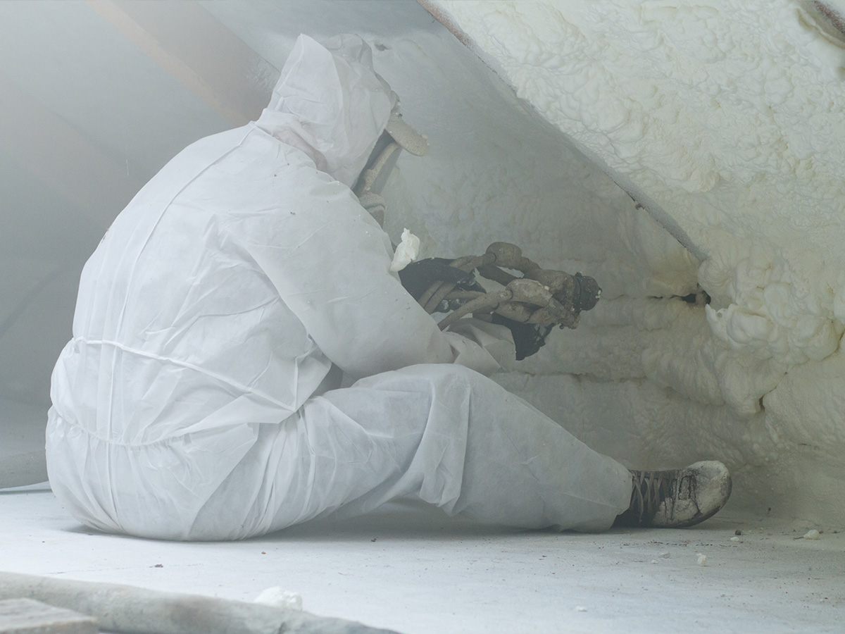 spray foam contractor wearing protective suit